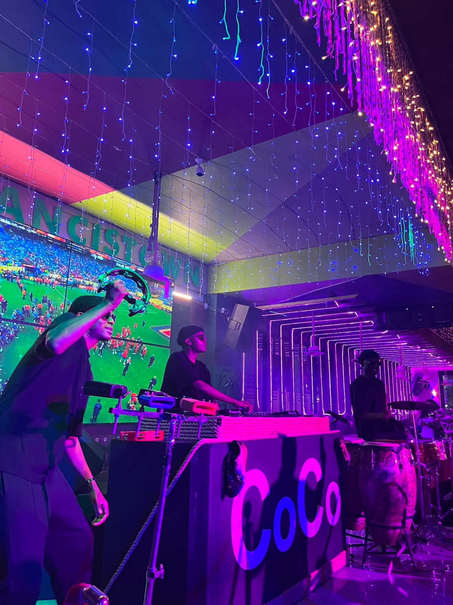 CoCo live band playing in blue light
