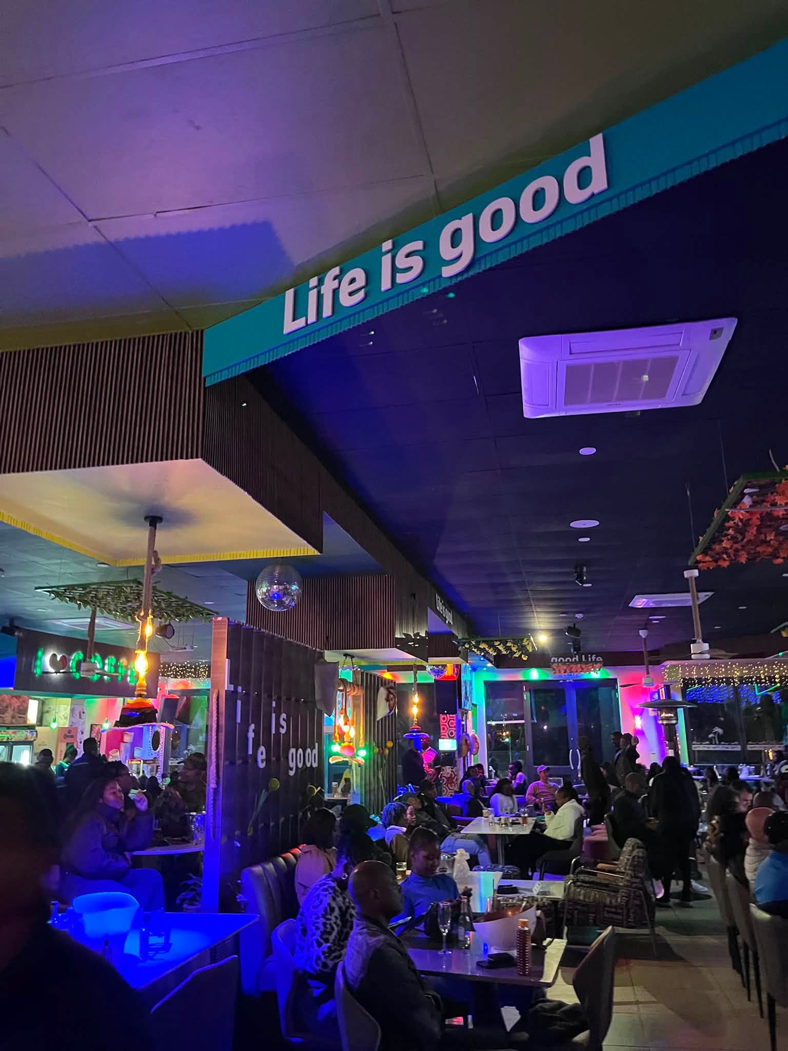 Life is Good sign above a full house inside Coconut Lounge